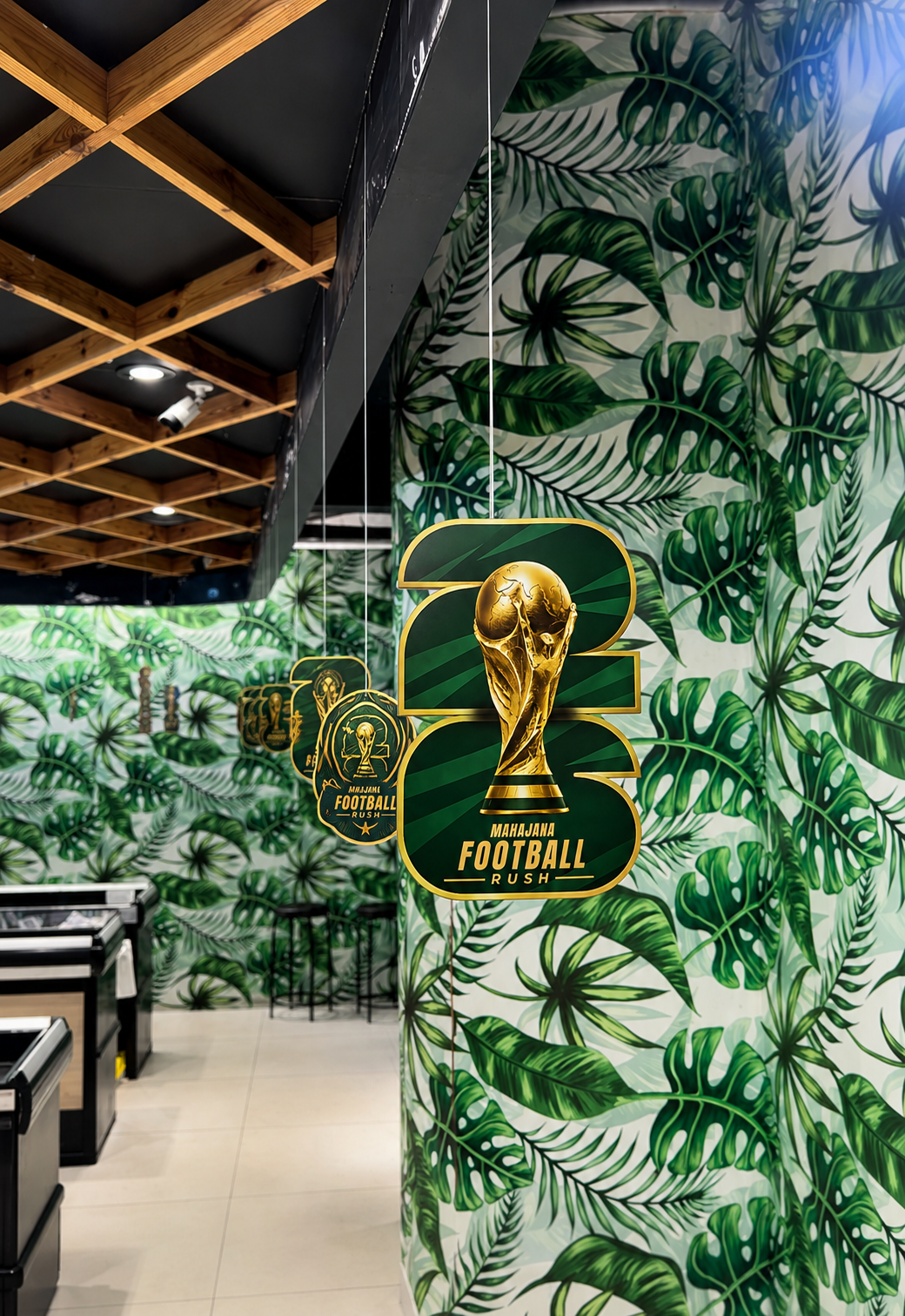 A Mahajana Football Rush graphic displayed on a pillar inside the supermarket.